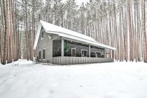 a cabin in the woods in the snow at Bellaire Cabin, 1 Mi to Schuss Mountain! in Bellaire