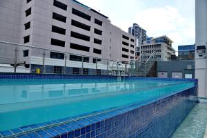 a large swimming pool in a city with buildings at Cresta Grande Cape Town in Cape Town