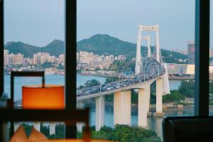 a view of a bridge with traffic on it at HUALUXE Xiamen Haicang Habour View - An IHG Hotel in Xiamen