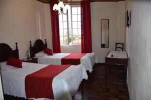 a hotel room with three beds and a window at Hotel GORDON in Funchal