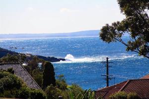a large body of water with waves in the ocean at Mollymook Ocean View Motel Rewards Longer Stays -over 18s Only in Mollymook