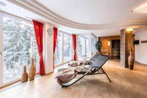 a room with a bed and large windows at die Aussicht in Finkenberg