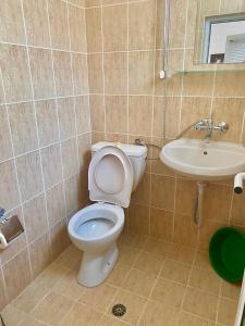 a bathroom with a toilet and a sink at Къща за гости Стоянови in Primorsko