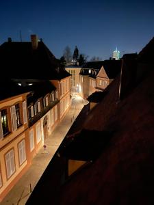 a view of a city street at night at Le Petit Linck - Typique au coeur de Colmar in Colmar