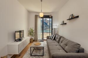 een woonkamer met een bank en een tafel bij LANA Sea View Apartment in Kotor