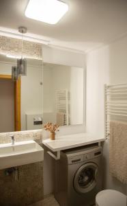 a bathroom with a washing machine and a sink at Open view Pinetree penthouse in Dehesa de Campoamor +13 photos