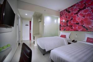 Voodi või voodid majutusasutuse favehotel Langko Mataram - Lombok toas