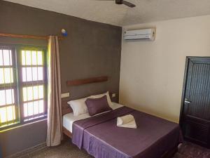 a bedroom with a bed with a hat on it at Urban Cliff Resort in Varkala