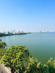 a large body of water with a city in the background at Ven Hồ Hotel in Hanoi