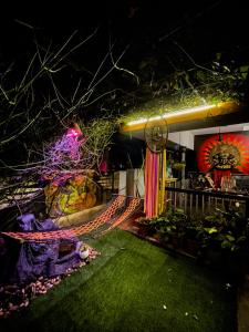 a building with a hammock in the yard at night at Indian Art Villa in Varkala