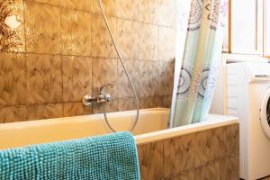 ein Badezimmer mit einer Badewanne und einem blauen Handtuch in der Unterkunft 2 Camere Panoramico nelle Dolomiti Bellunesi in Pedavena