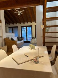a white table with a glass on top of it at Gabriel’s Home in Salò