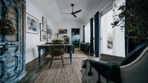 a dining room with a table and a chair at Mill House Studio - a romantic retreat in Lyonville
