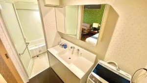 a bathroom with a sink and a mirror at One More Heart Fushimi Inari in Momoyama-chō +37 photos