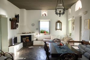 a living room with a table and a couch at Armira seaside house in Antiparos