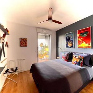 - une chambre avec un lit et un ventilateur de plafond dans l'établissement Chambre D'hôtes sur Île de Nantes, à Nantes