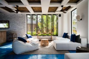 a living room with white furniture and a large window at Ahu Bay in Ahungalla