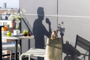 a shadow of a man and a woman on a wall at L-Avenue in Brussels