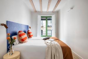 a white room with a bed and a window at Calatrava - Darya Living in Madrid