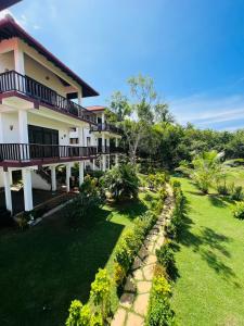 a house with a lawn in front of it at Ashansa Lagoon Resort in Tangalle