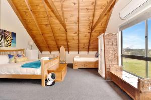 a bedroom with two beds and a large window at Silver Springs Estate in Rothbury