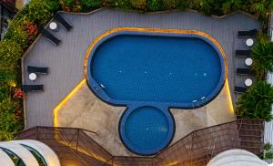 an overhead view of a blue swimming pool at A-ONE Bangkok Hotel in Bangkok