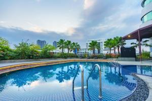 a swimming pool at a hotel with palm trees at A-ONE Bangkok Hotel in Bangkok