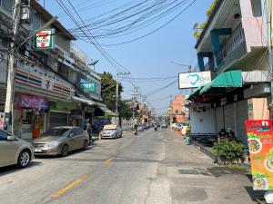 a street with cars parked on the side of the road at Love CNX Guesthouse in Chiang Mai +29 photos