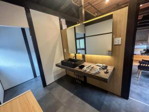 a bathroom with a sink and a mirror at Kototoki - Yu - in Gotsu
