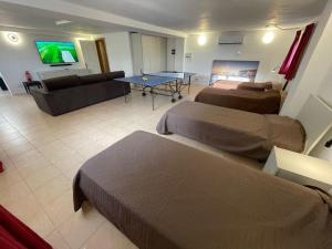 a hotel room with two beds and a couch at Villa Bernardette in Xagħra