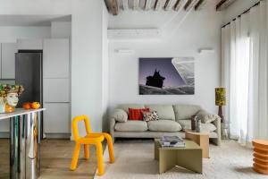 a living room with a couch and a table at Calatrava - Darya Living in Madrid +127 photos