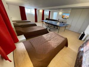 a hotel room with two beds and a table at Villa Bernardette in Xagħra