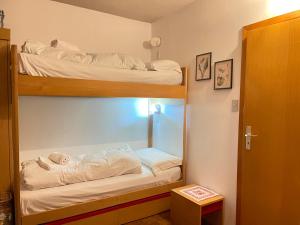 two bunk beds in a room with a mirror at Dolomites Dream Marmolada in Rocca Pietore