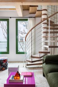 a living room with a staircase and a purple table at Calatrava - Darya Living in Madrid