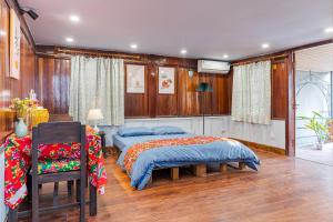 a bedroom with two beds and a table and chairs at Hanoi Retro 80S Homestay in Hanoi