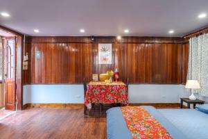 a room with two beds and a table in it at Hanoi Retro 80S Homestay in Hanoi