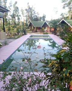 a pool of water in front of a house at Tentstar Eco Resort in San Vicente
