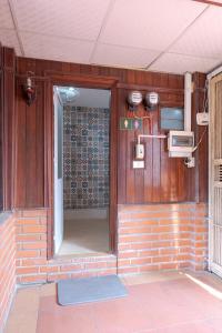 an entrance to a room with a brick wall at Hanoi Retro 80S Homestay in Hanoi