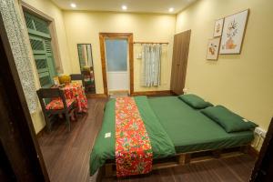 a bedroom with a bed and a table with a chair at Hanoi Retro 80S Homestay in Hanoi