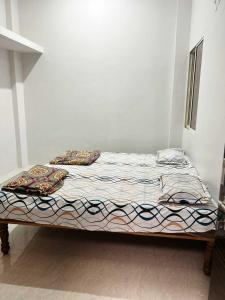 a bed sitting in a room with a bedspread on it at Nadiya Kinare in Maheshwar