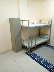 um quarto com 2 beliches num quarto em SmSma BedSpace Hostel em Ajman