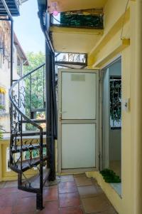 a large white door on the side of a building at Hanoi Retro 80S Homestay in Hanoi