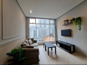 a living room with a couch and a table at Soho Suites KLCC by Harry in Kuala Lumpur