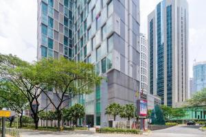 a tall building in a city with tall buildings at Soho Suites KLCC by Harry in Kuala Lumpur