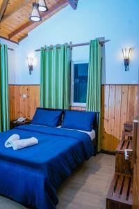 Postel nebo postele na pokoji v ubytování Blue Moon Residency