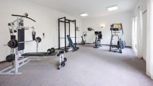 een fitnessruimte met diverse loopbanden en machines bij Hotel Am Kurpark Späth in Bad Windsheim