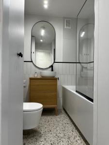 a bathroom with a tub and a sink and a mirror at OhMyHome - Platynowa in Warsaw