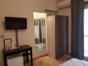a living room with a television and a sliding glass door at B&B Monté in Montesilvano