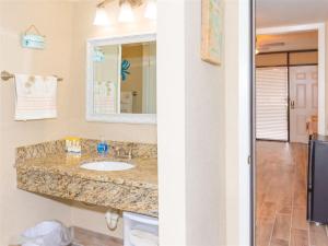 a bathroom with a sink and a mirror at Laguna Reef #116 - The Heron Room in Rockport +29 photos