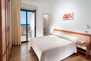 Postel nebo postele na pokoji v ubytování Hotel Olympic